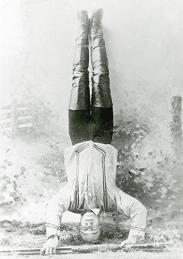Mishaps in shooting exhibitions often came as a result unusual stances such as Johnny Baker who's ready to shoot at a target while standing on his head. Vincent Mercaldo Collection. P.71.34