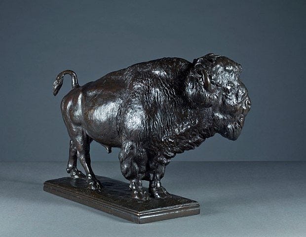 Bronze sculpture of a bison viewed from a different angle, highlighting its strong stance, detailed fur texture, and muscular form on a rectangular base.