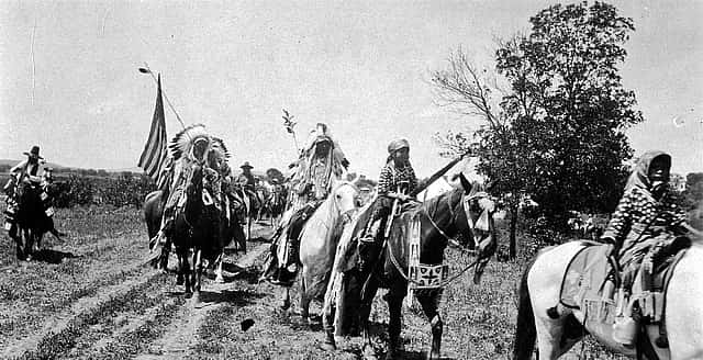 Horse and riders parading at Crow Fair, Crow Agency, Montana. Photo by W.H.D. Koerner, 1927. P.78.4452 (detai)