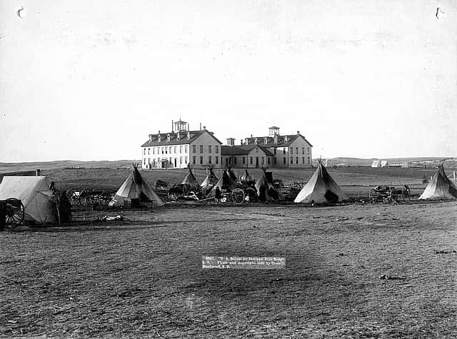 “U.S. School of Indians at Pine Ridge, 1891.” John C.H. Grabill was an early and active photographer in South Dakota. This print captures the stark contrast between the traditional ways of the Native Americans and the new social order. MS 35 Richard Pohrt Collection. P.35.17.2