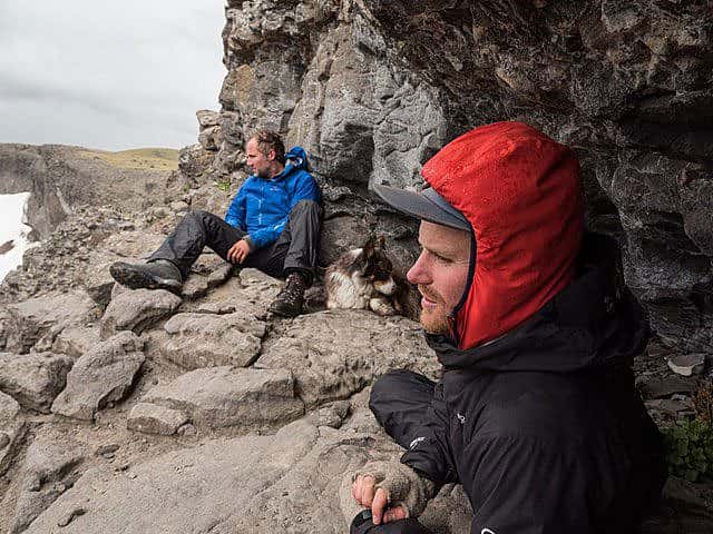 Arthur Middleton, left, and Joe Riis watch for elk in Yellowstone while taking cover from a storm. Photo by Shane Moore.