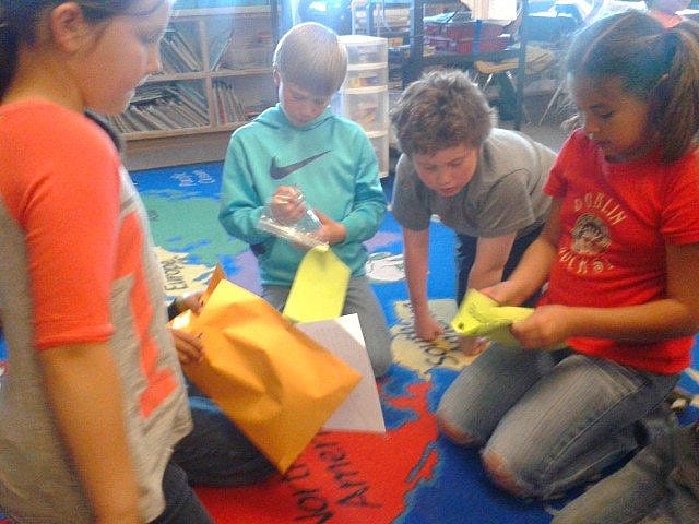Several of Ms. Krejci's students counting the money they had raised.