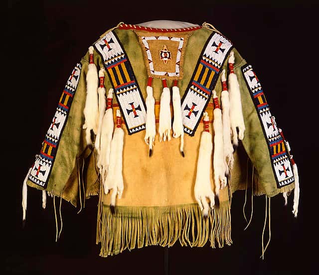 Man's Shirt. Austin Box, Southern Ute, Security, Colorado, 1989. Tanned deer hide, pre-1880 glass beads, seam binding, ermine, dyed porcupine quills, commercial dyes, nylon thread. Gift of Mr. & Mrs. William D. Weiss. NA.202.1007