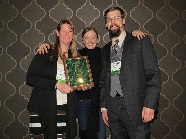 Melissa and Brandon accept the High Flyer Award present by Helen Dishaw, VP of IAATE.