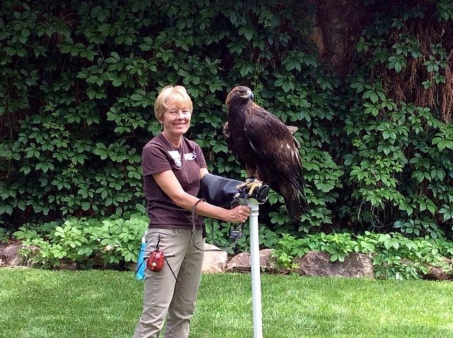 Woman holding golden eagle.