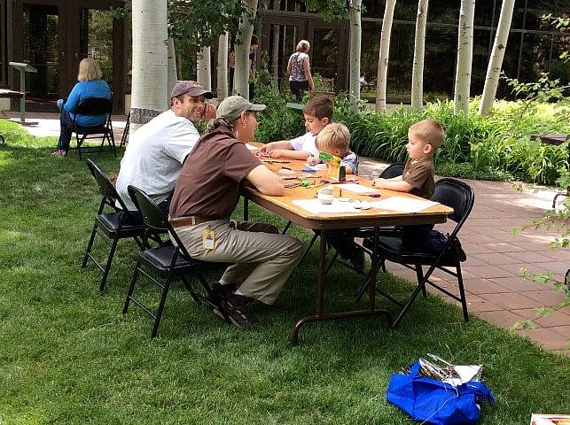 Kids creating their own vulture mobiles.