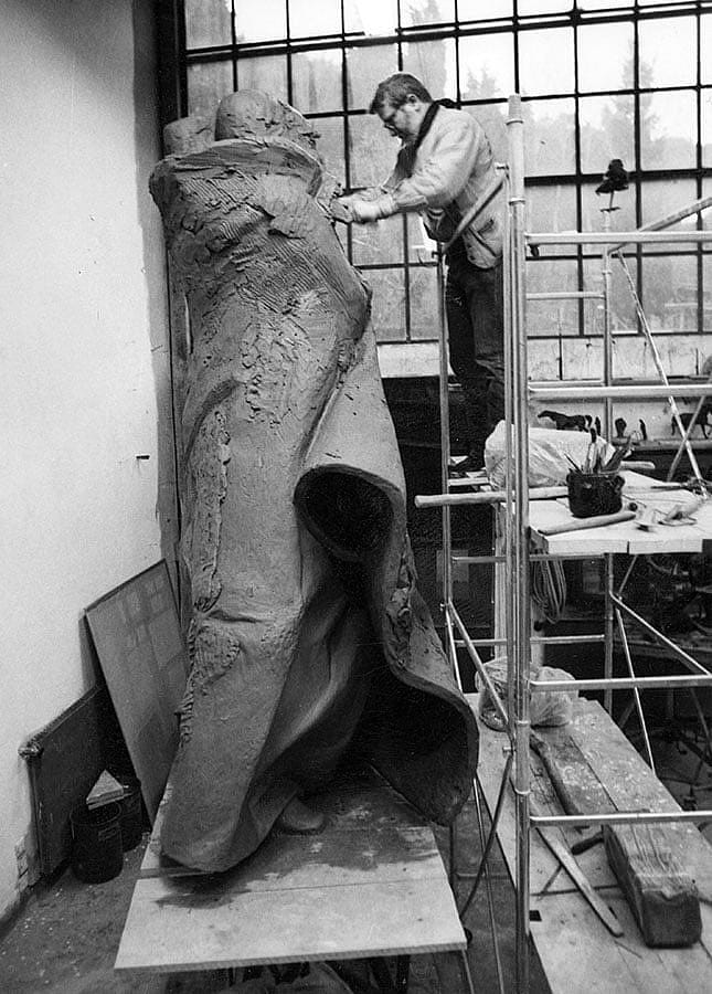Harry Jackson uses an oversized shaping tool to add details to the sculpture.