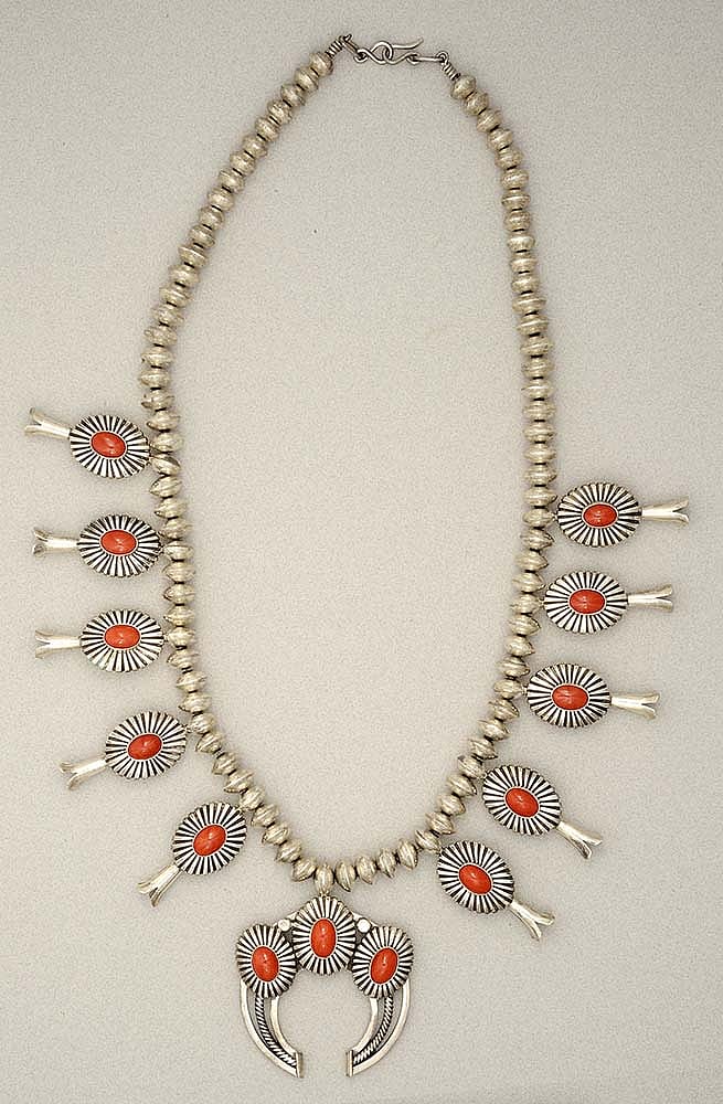This necklace exemplifies Walsh's attraction to contemporary American Indian silver artists. This silver and coral squash blossom necklace was created by Navajo silversmith Thomas Jim late 20th century. Gift of Margo Grant Walsh, in Appreciation of Ann Simpson. 1.69.6360