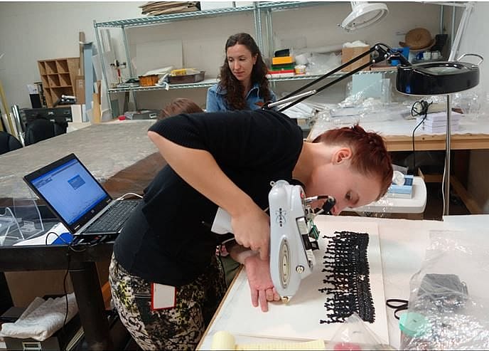 Intern Katrina Zacharias analyzing black replacement beads to compare their composition to the original beads found in the object.
