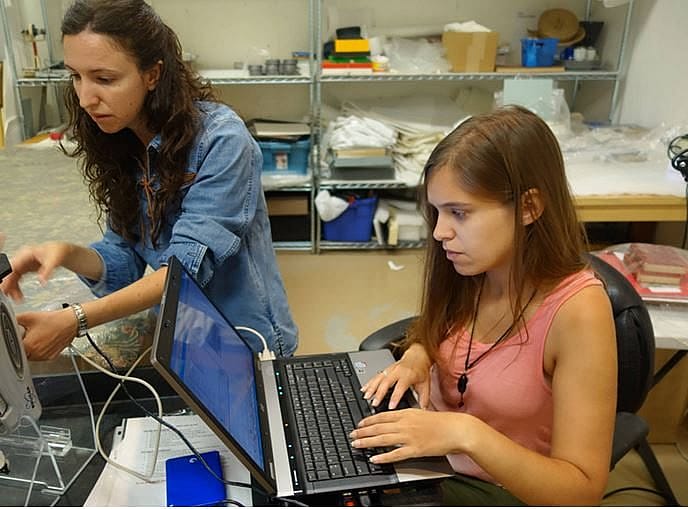Interns Blanca Guerra and Zulema Garcia collecting data using XRF software.