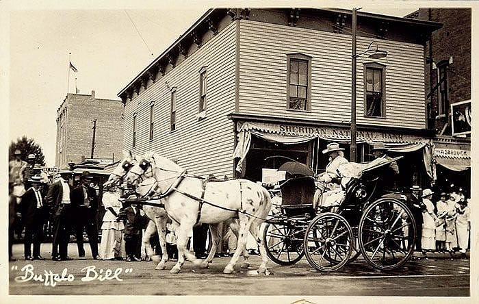 Buffalo Bill driving the Spider Phaeton carriage behind two white dappled horses in Sheridan, Wyoming, ca. 1916. MS 6 William F. Cody Collection, McCracken Research Library. P.69.1672