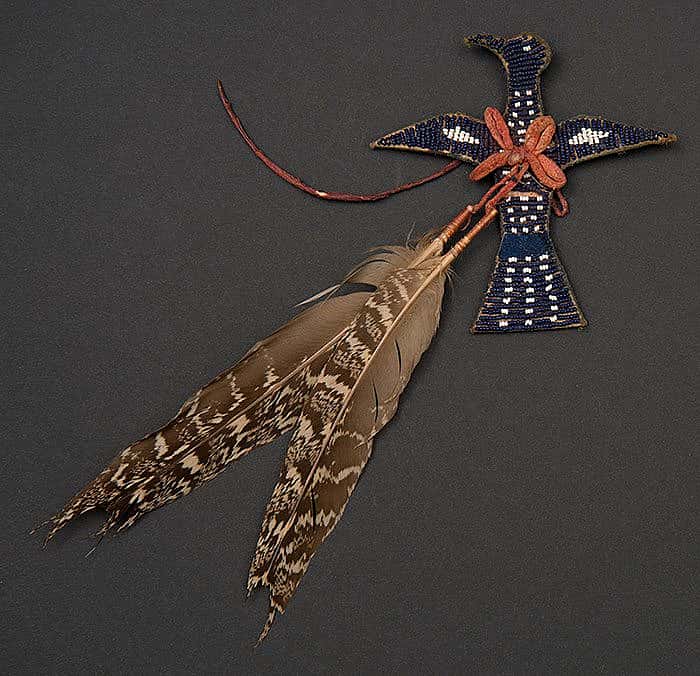 Apsaalooke (Crow) charm made from tanned hide, glass beads, pigments, and sage grouse feathers, ca. 1900. Paul Dyck Plains Indian Buffalo Culture Collection. NA.502.345
