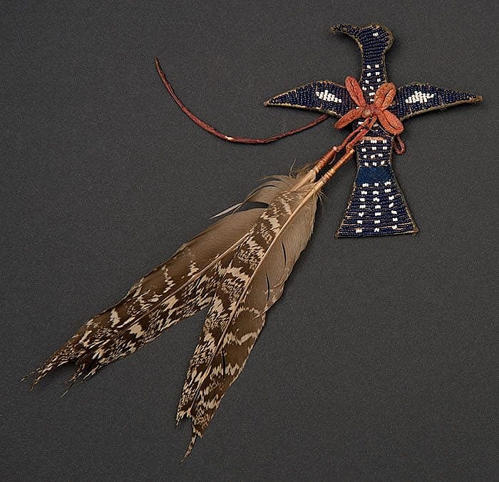 Apsaalooke (Crow) charm made from tanned hide, glass beads, pigments, and sage grouse feathers, ca. 1900. Paul Dyck Plains Indian Buffalo Culture Collection. NA.502.345