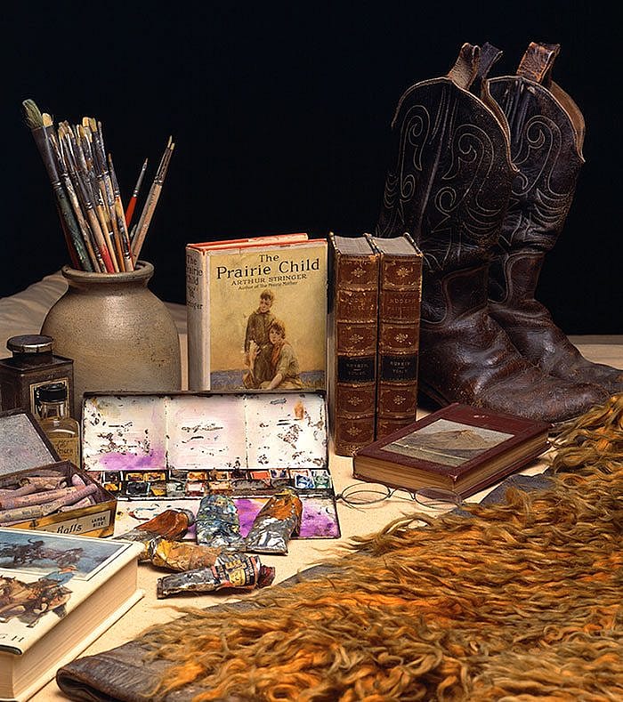 W.H.D. Koerner's paints, brushes, artist's materials, cowboy boots, wooly chaps, "The Prairie Child," "North of 36," "Ruskin's Modern art," and "What is Art." All from W.H.D. Koerner Studio Collection. Gift of the artist's heirs, W.H.D. Koerner III and Ruth Koerner Oliver.