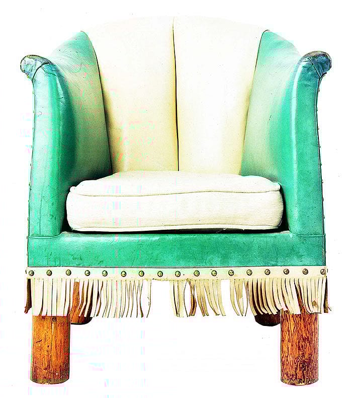 Barrel chair, green/white leather upholstered. Blue and white top-grain leather originally with leather-covered cushion, fringe trim. Collection of the Stonehouse Family