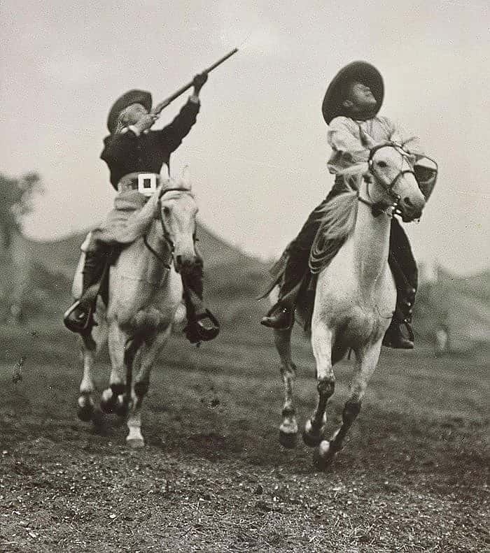 The Wild West certainly had all the trappings of excitement and drama. Here Buffalo Bill shoots glass targets from horseback as a second cowboy tosses the balls, ca. 1908. Original Buffalo Bill Museum Collection. P.69.3