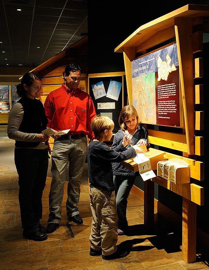 A family gets started with their Adventure Passports in the Draper Natural History Museum.