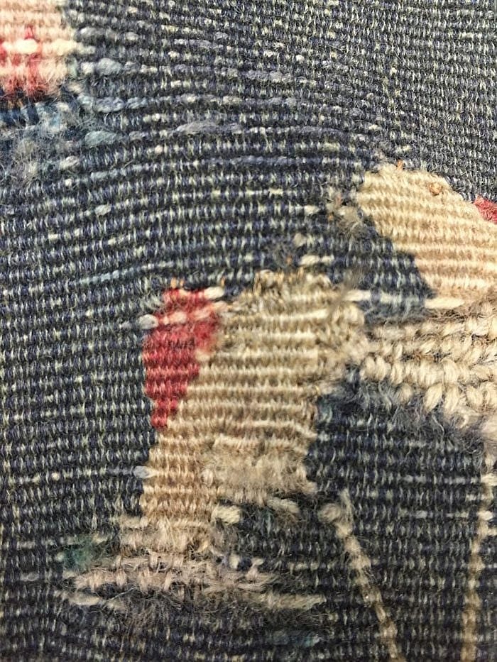Mismatched navy blue thread removed
