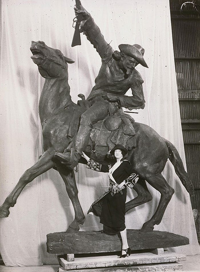 Gertrude Vanderbilt Whitney poses with "Buffalo Bill - The Scout," her 1924 sculpture of William F. Cody. MS6 William F. Cody Collection, McCracken Research Library. P.69.517