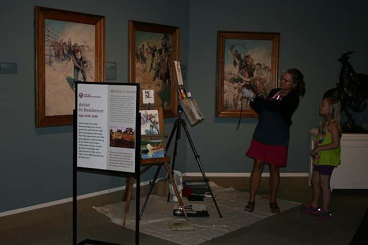 Farrier demonstrating her work to a young visitor in the Whitney Western Art Museum.