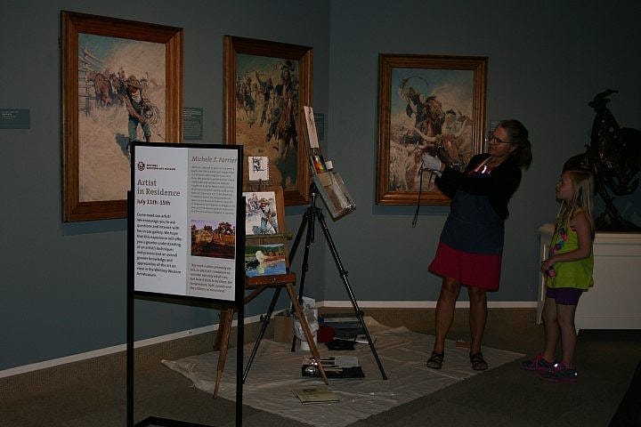 Farrier demonstrating her work to a young visitor in the Whitney Western Art Museum.