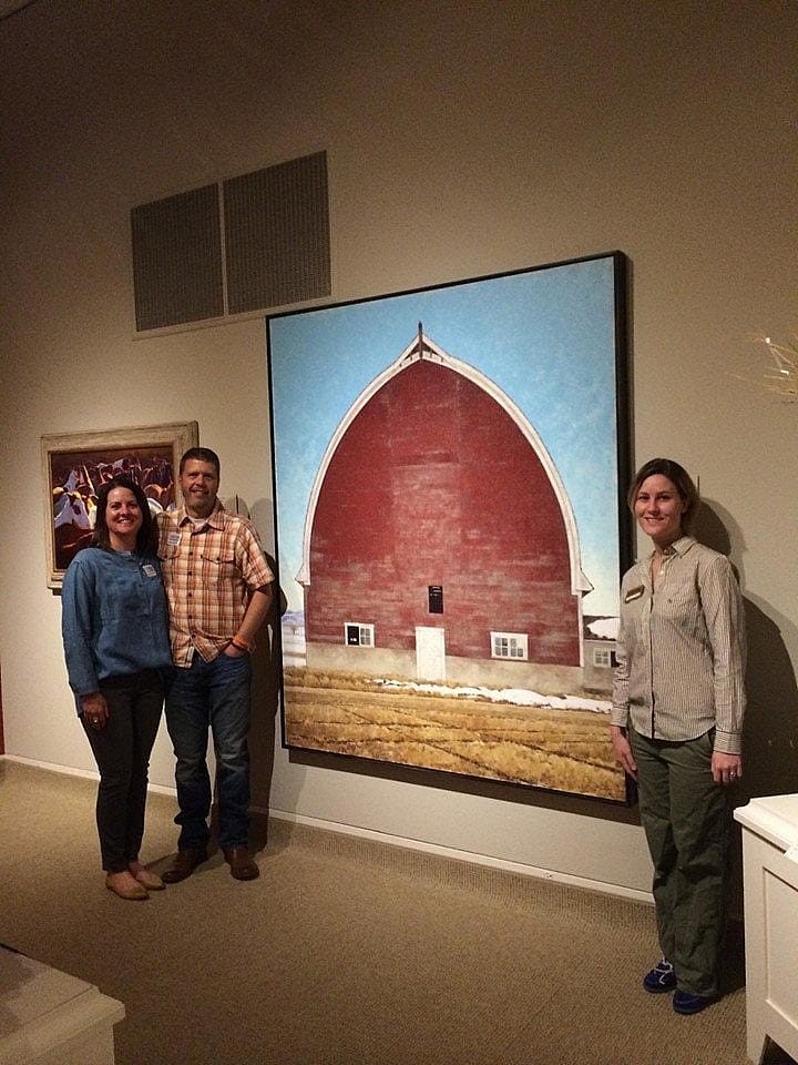 Paula and Jared Sanders next to their painting in the Whitney Museum.