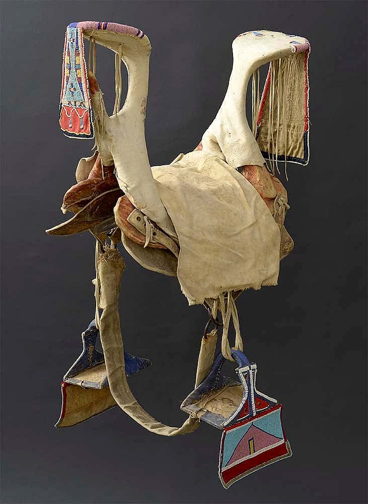 Crow saddle and stirrups, ca. 1900. Paul Dyck Plains Indian Buffalo Culture Collection, acquired through the generosity of the Dyck family and additional gifts of the Nielson Family and the Estate of Margaret S. Coe. NA.403.281