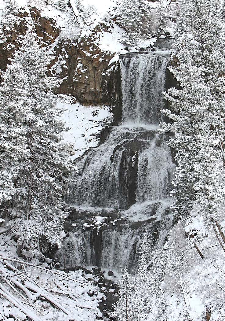 An early winter blanket of snow covers the landscape around Undine Falls in Yellowstone National Park. Photo by Jim Peaco.