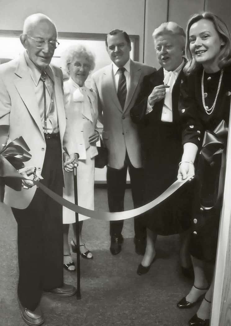 Dr. Harold McCracken, left, cuts the ribbon at the opening of the Buffalo Bill Historical Center's McCracken Research Library on August 15, 1980. He is accompanied, left to right, by Mrs. McCracken, Charles Duncan, Chair of the Center's Board of Trustees, Peg Coe, and Ann Duncan.