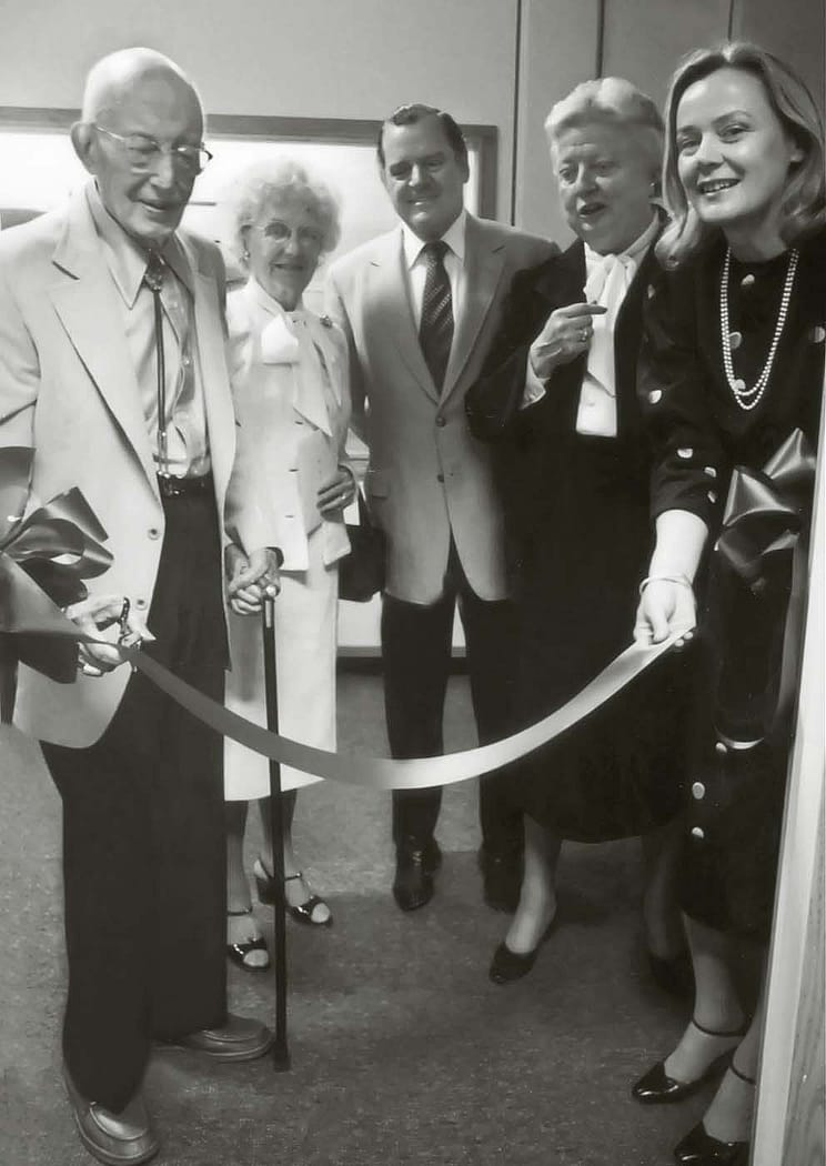 Dr. Harold McCracken, left, cuts the ribbon at the opening of the Buffalo Bill Historical Center's McCracken Research Library on August 15, 1980. He is accompanied, left to right, by Mrs. McCracken, Charles Duncan, Chair of the Center's Board of Trustees, Peg Coe, and Ann Duncan.