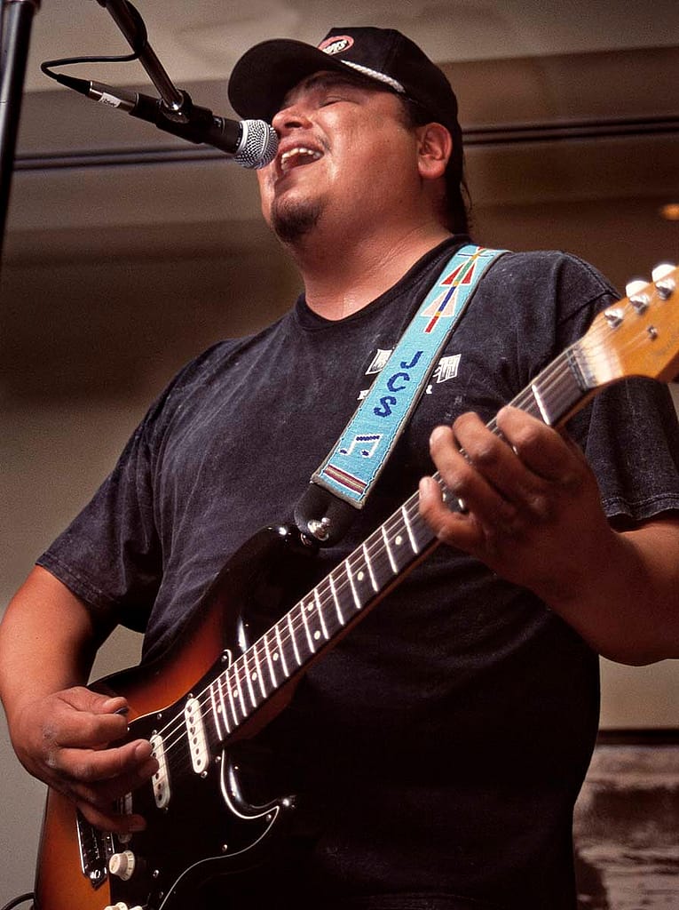 Musician, singer, and songwriter Jared Stewart of Crow Agency, Montana, performs a combination of blues, rock, and pop to open the 2004 Plains Indian Museum Seminar. The seminar celebrated the living traditions of music and dance for Native people of the Great Plains. Chris Gimmeson photo.