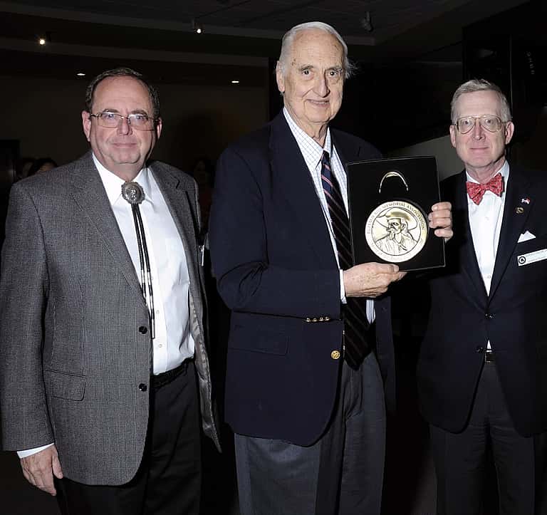 Willis McDonald IV, center, receives the Buffalo Bill Center of the West's Spirit of the West Award in 2012 with Bruce Eldredge (L), the Center's Executive Director and CEO, and Barron Collier II, Board of Trustees Chairman.