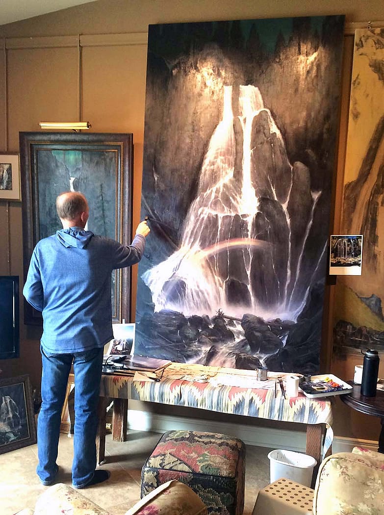 Artist M.C. Poulsen works on one of a series of paintings of waterfalls found in Yellowstone National Park, where more than 500 falls can be found.