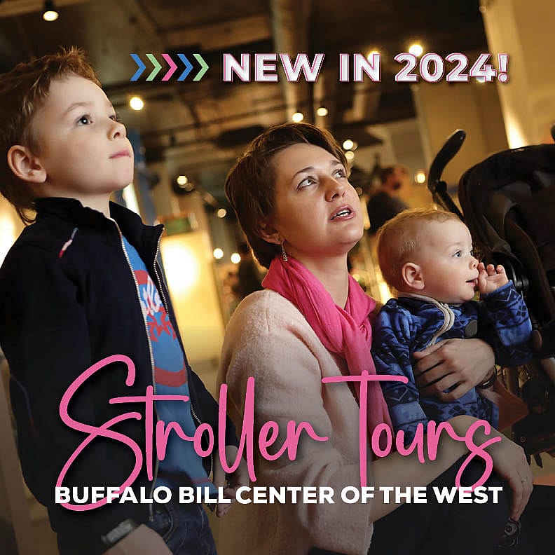 A young family with a stroller look at museum exhibits.