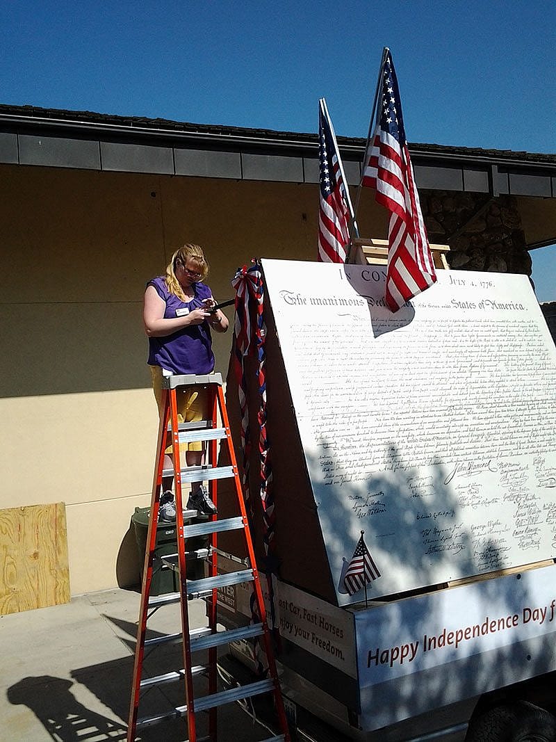 Samantha Harper decorating the peak of the July 4th float