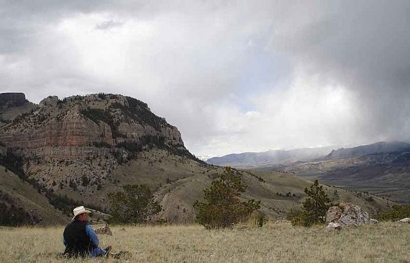 Research Assistant Richard Jones monitors a Golden Eagle nest on the distant ledge.
