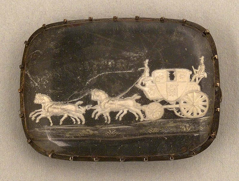 Agate brooch given to Mrs. William F. Cody, i.e. Louisa Cody, and featuring a coach and four, ca. 1890. Hand-carved, 1 x .75 inches. Original Buffalo Bill Museum Collection. 1.69.335