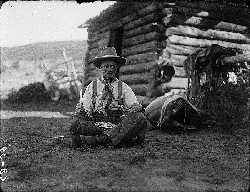 Old Charlie Collins looks a bit "worse for wear" with his tin plate of trail vittles, ca. 1920. Charles Belden black and white glass plate negative. Gift of Mr. and Mrs. Charles Belden. PN.67.39
