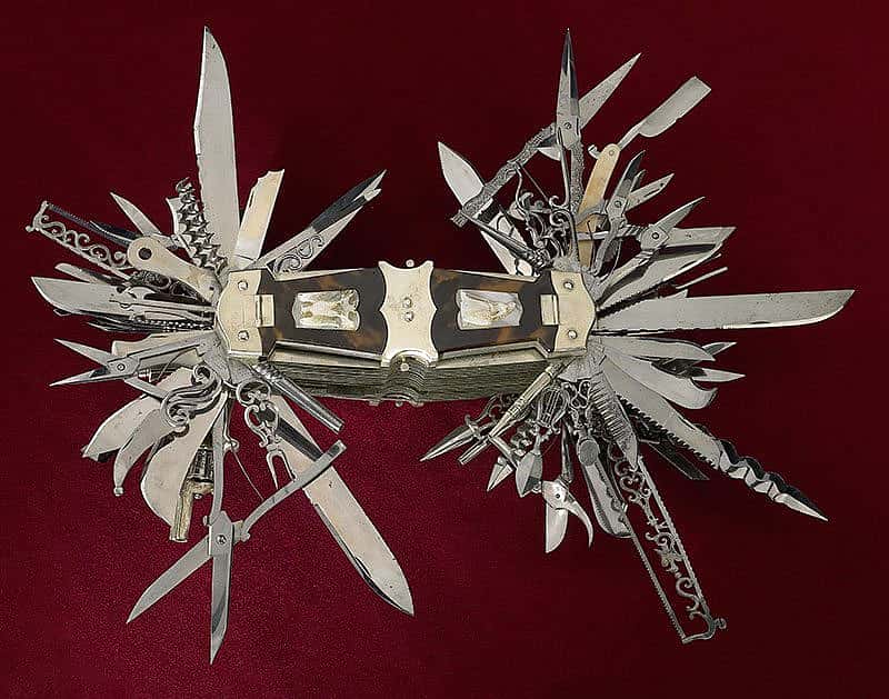 In this view, the tortoise shell handle covers over compartments are closed. Zoom into the image below to see the miniature tools the compartments contain.