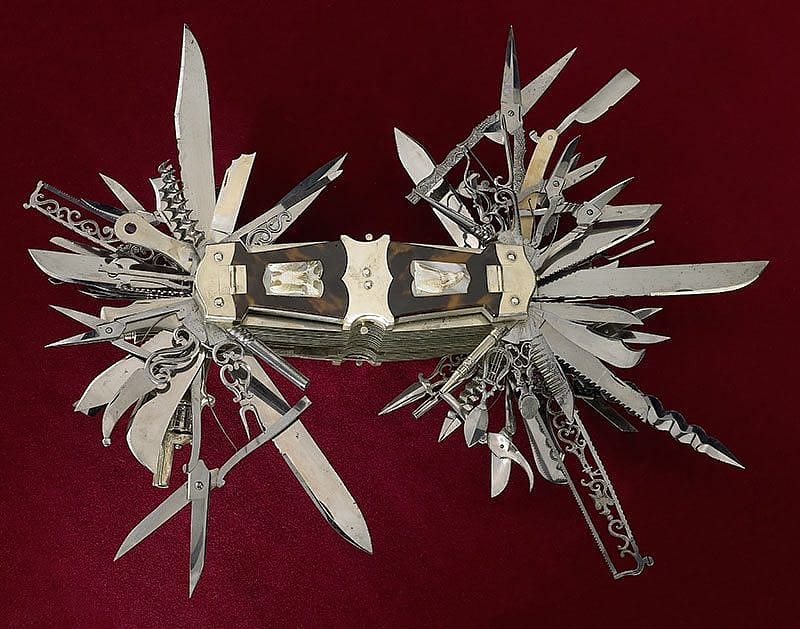 In this view, the tortoise shell handle covers over compartments are closed. Zoom into the image below to see the miniature tools the compartments contain.