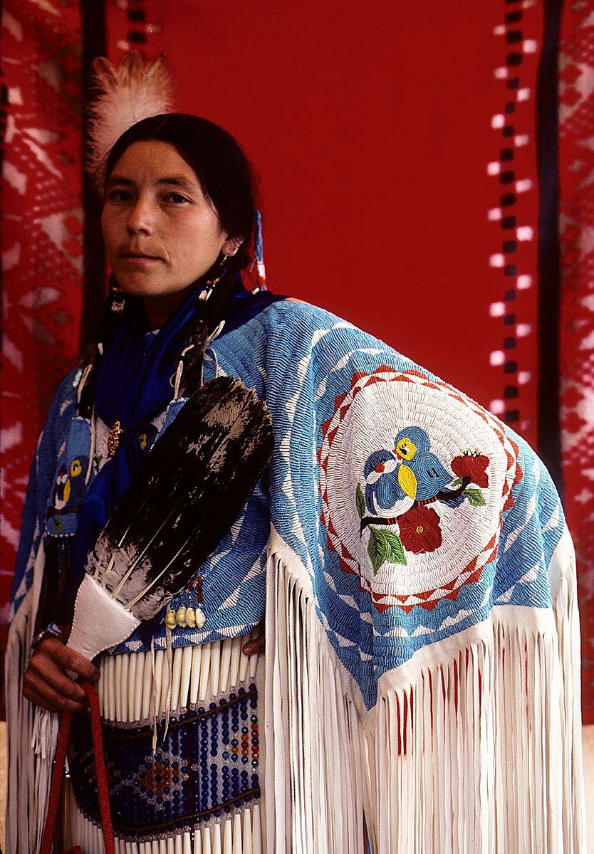 Woman displaying detailed beadwork on her shawl. Ken Blackbird photograph. MS 426 Ken Blackbird Collection.
