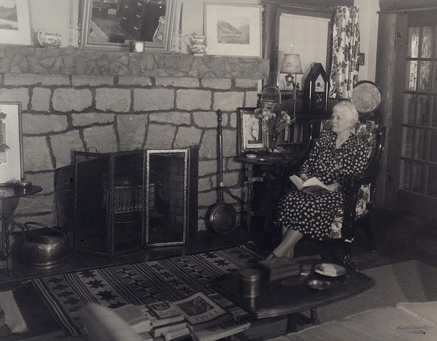 Mary Jester Allen in front of the fireplace in the Buffalo Bill Museum, 1953. Mrs. Allen actually lived in the museum from the time of its construction until her death in 1960. Mary Jester Allen Collection. P.69.570