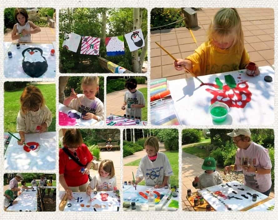 Children paint outdoors during a Family Fun Day at the Buffalo Bill Center, creating colorful art projects inspired by nature and wildlife in a garden setting.