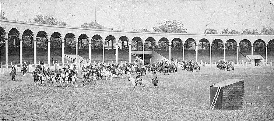Buffalo Bill's Wild West arena with Buffalo Bill on horseback and Indians practicing a riding drill. P.6.354