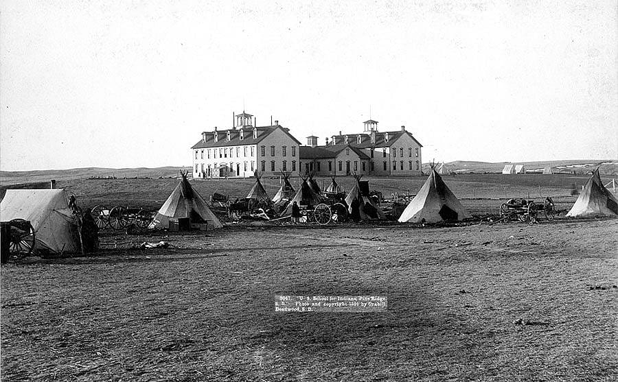 "U.S. School of Indians at Pine Ridge, 1891." John C.H. Grabill was an early and active photographer in South Dakota. This print captures the stark contrast between the traditional ways of the Native Americans and the new social order. MS 35 Richard Pohrt Collection. P.35.17.2