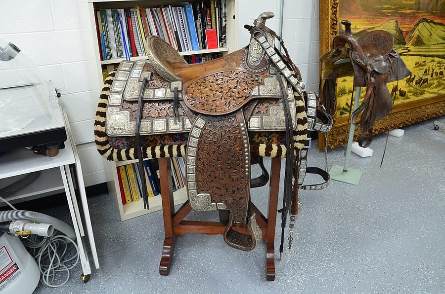 The California Mission Saddle shown with its breast collar and bridle in the conservation lab before treatment. Acc # 1.69.376A
