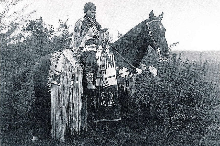 Cayuse woman rider on horseback. Photograph by E.S. Curtis from "The North American Indian." Gift of Douglas L. Manship.