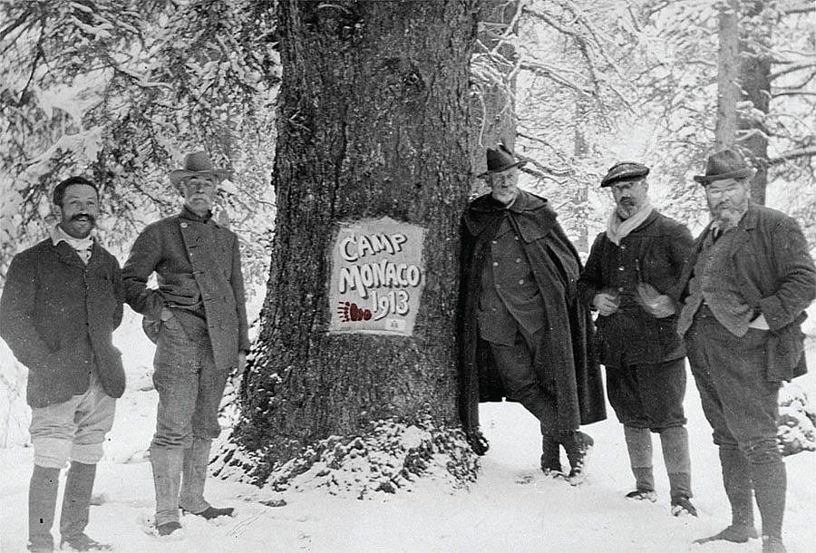 Camp Monaco, near Buffalo Bill's hunting lodge, northwest Wyoming, September 1913. Prince Albert I leans on the Camp Monaco tree. MS6 William F. Cody Collection. P.69.0296