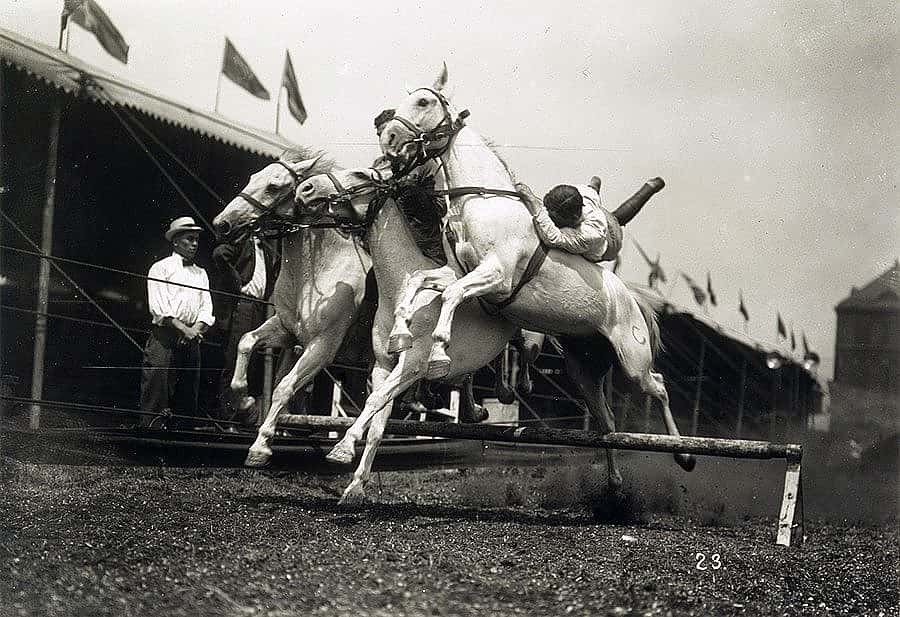 "Men riding three horses over jump." Equine drama of Buffalo Bill’s Wild West, from a glass plate negative attributed to E.E. Henry. PN.47.21