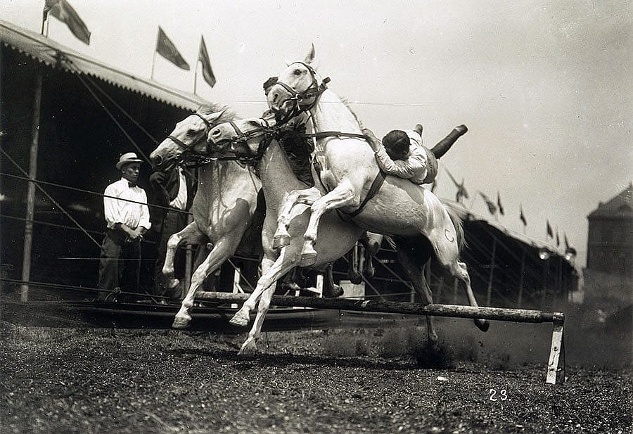"Men riding three horses over jump." Equine drama of Buffalo Bill’s Wild West, from a glass plate negative attributed to E.E. Henry. PN.47.21